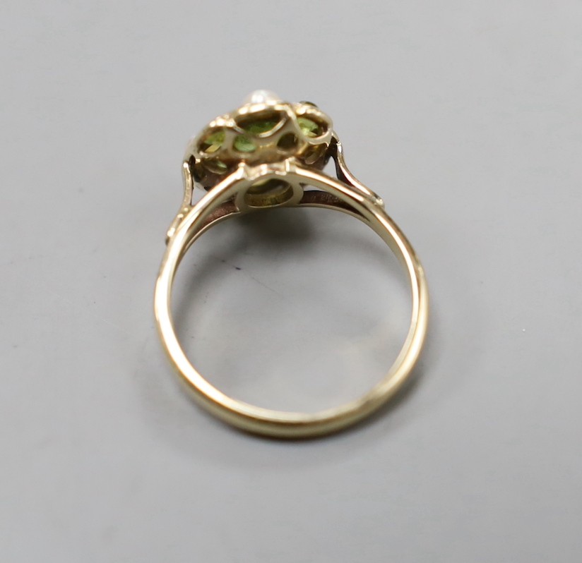 An early 20th century yellow metal, peridot and split pearl cluster set dress ring, size N, gross weight 3 grams.